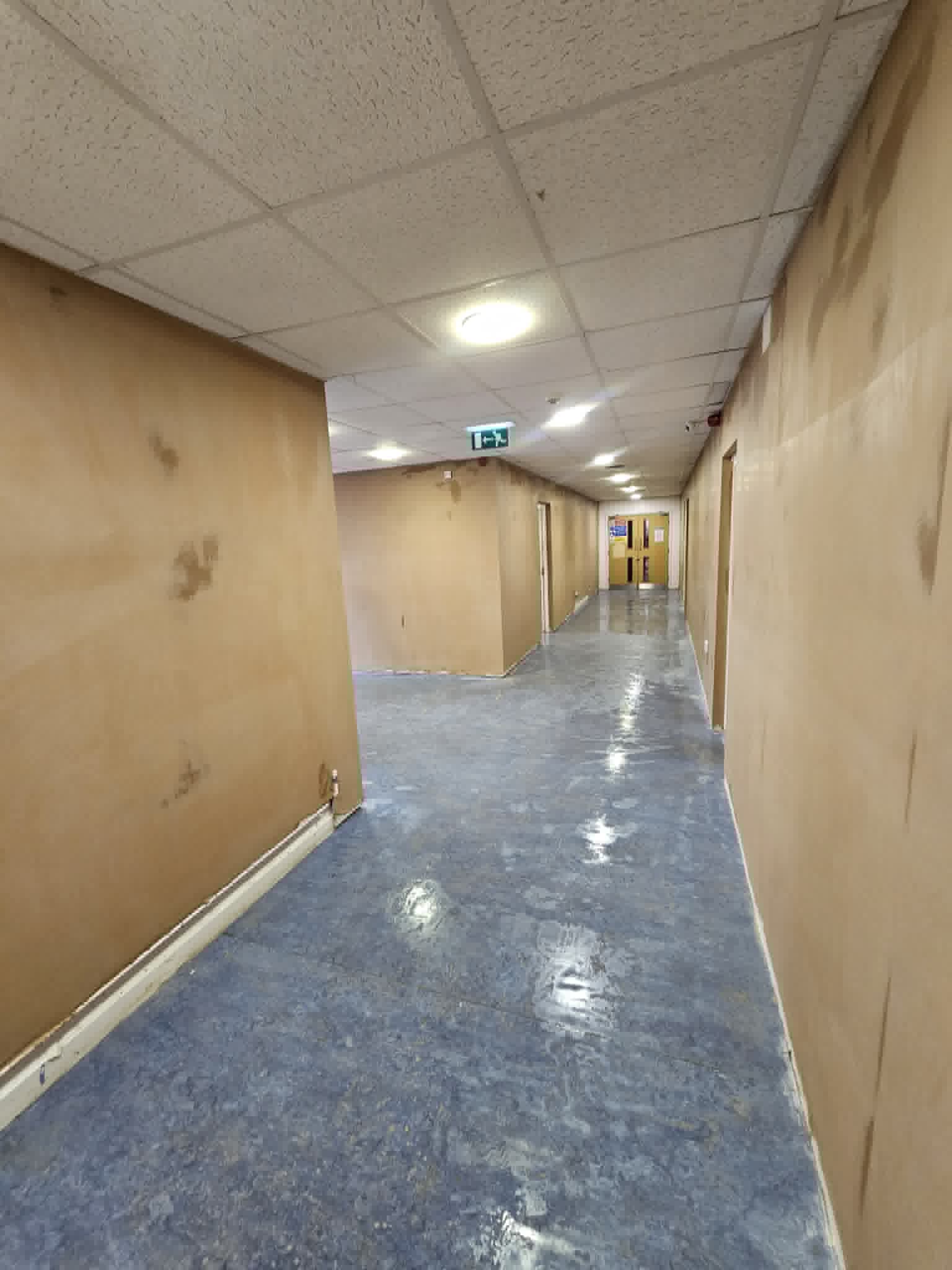 Long commercial corridor after plastering work