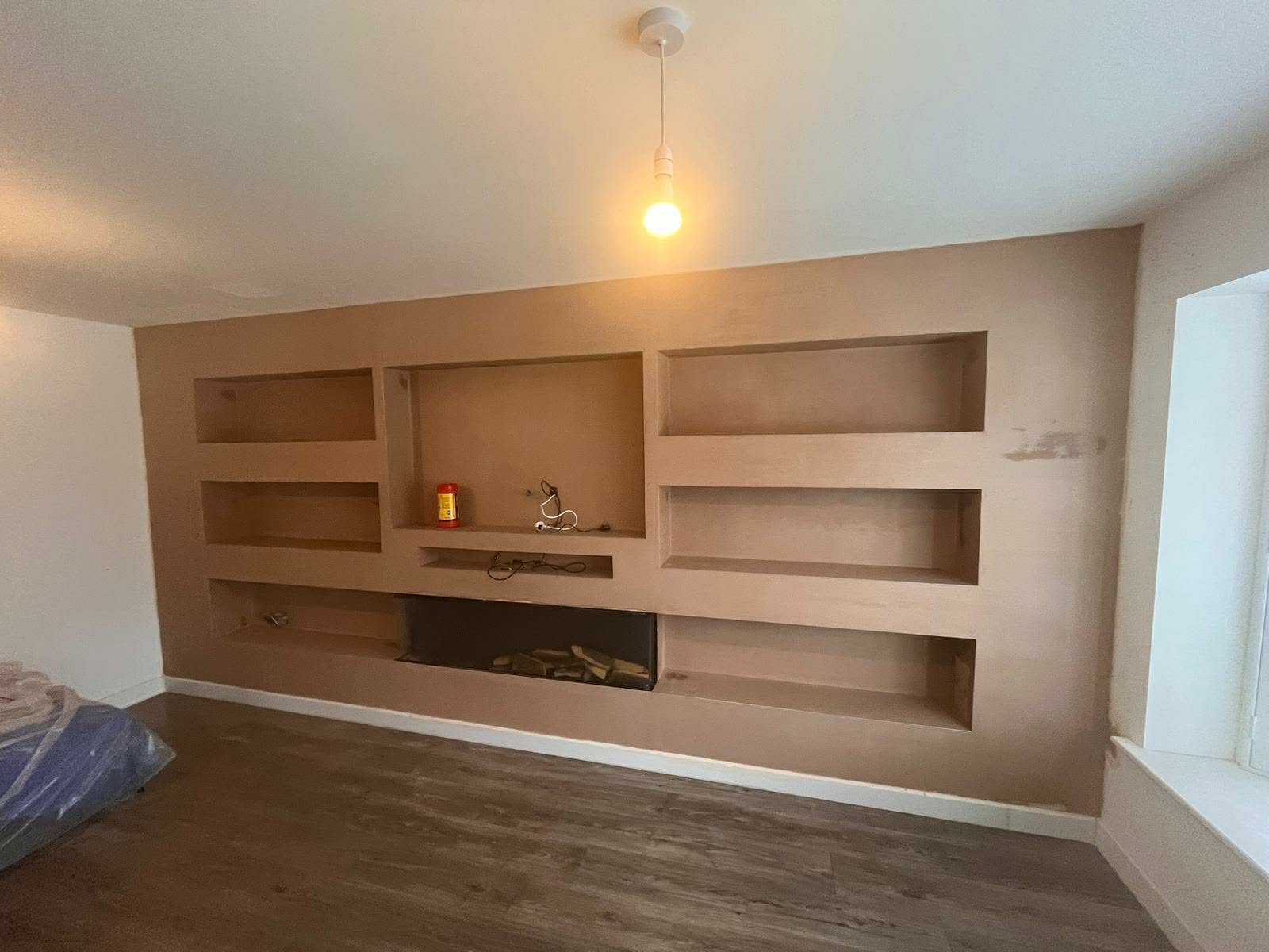 Completed room featuring a plastered media wall