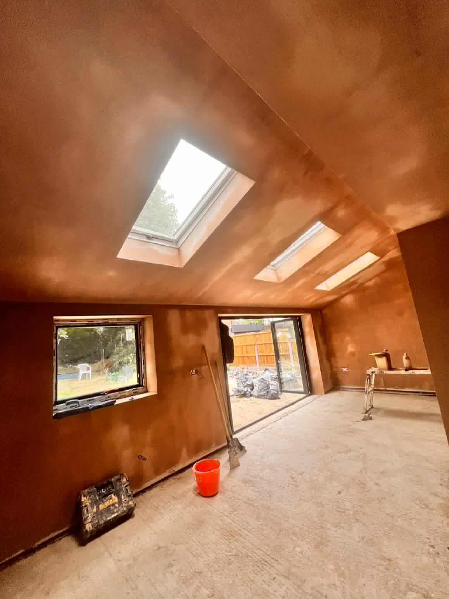Loft conversion with newly plastered pitched ceiling and walls