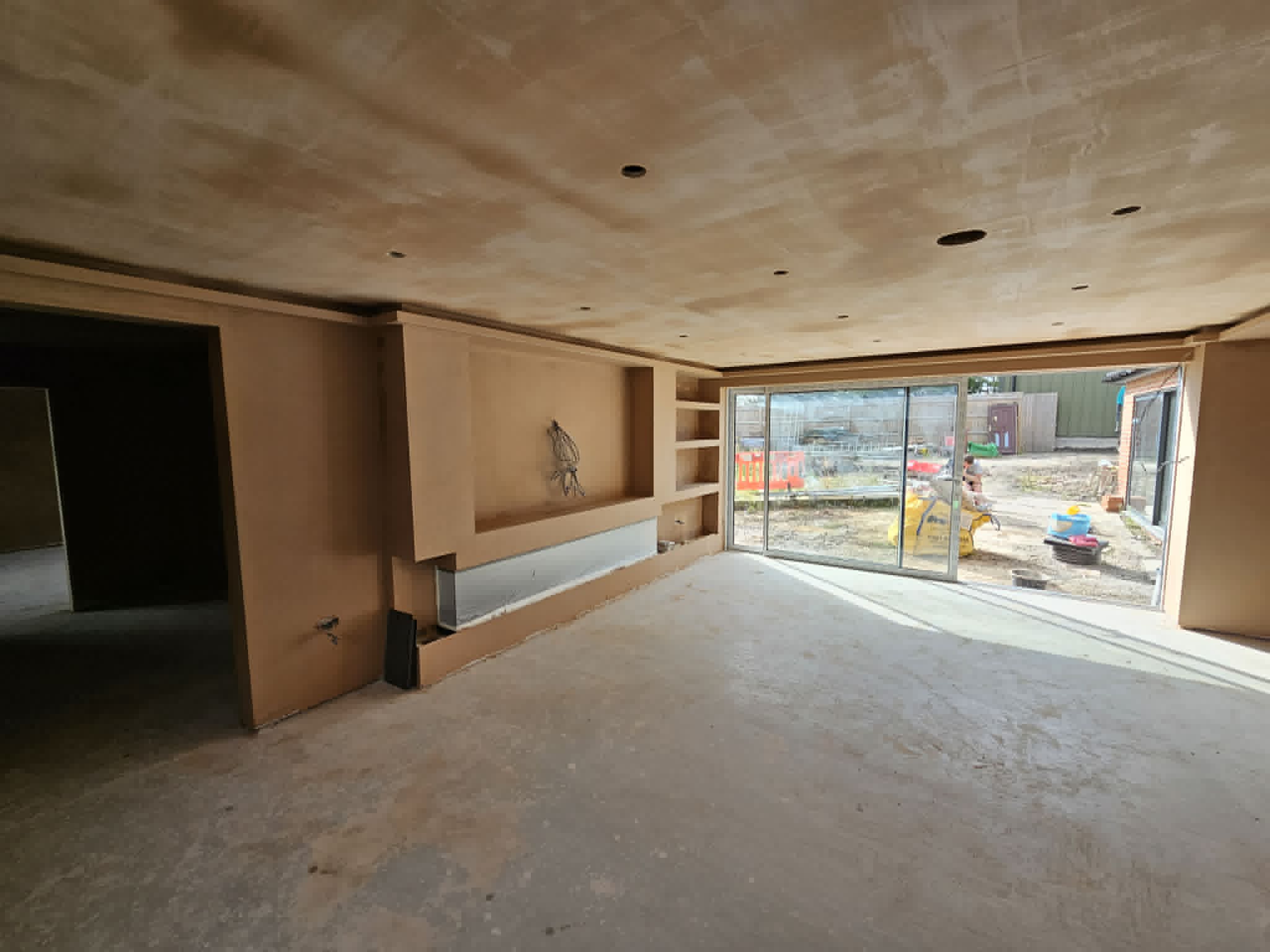 Large open-plan room after wall and ceiling plastering