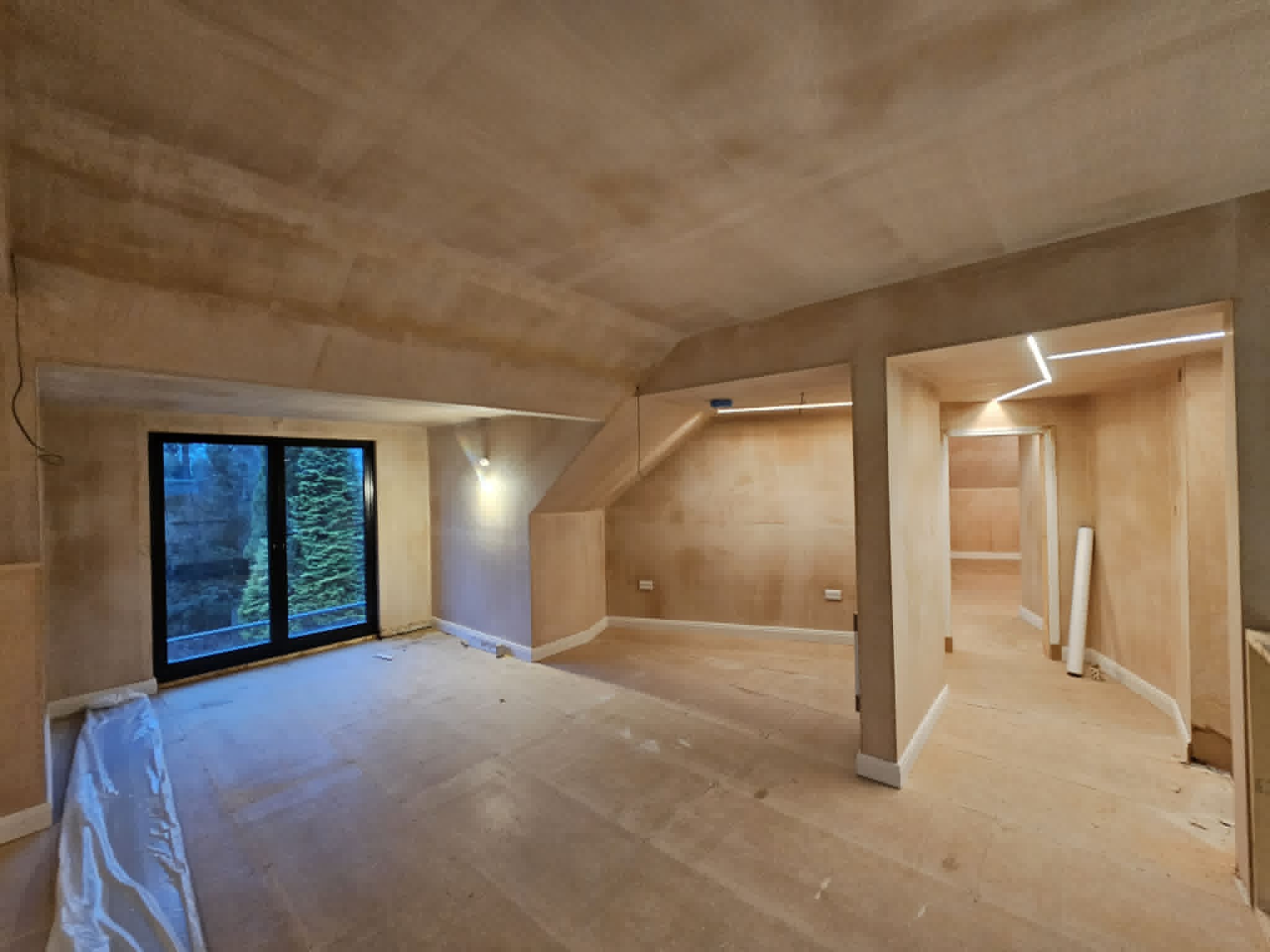 Open-plan renovation with smooth plastered walls and ceiling