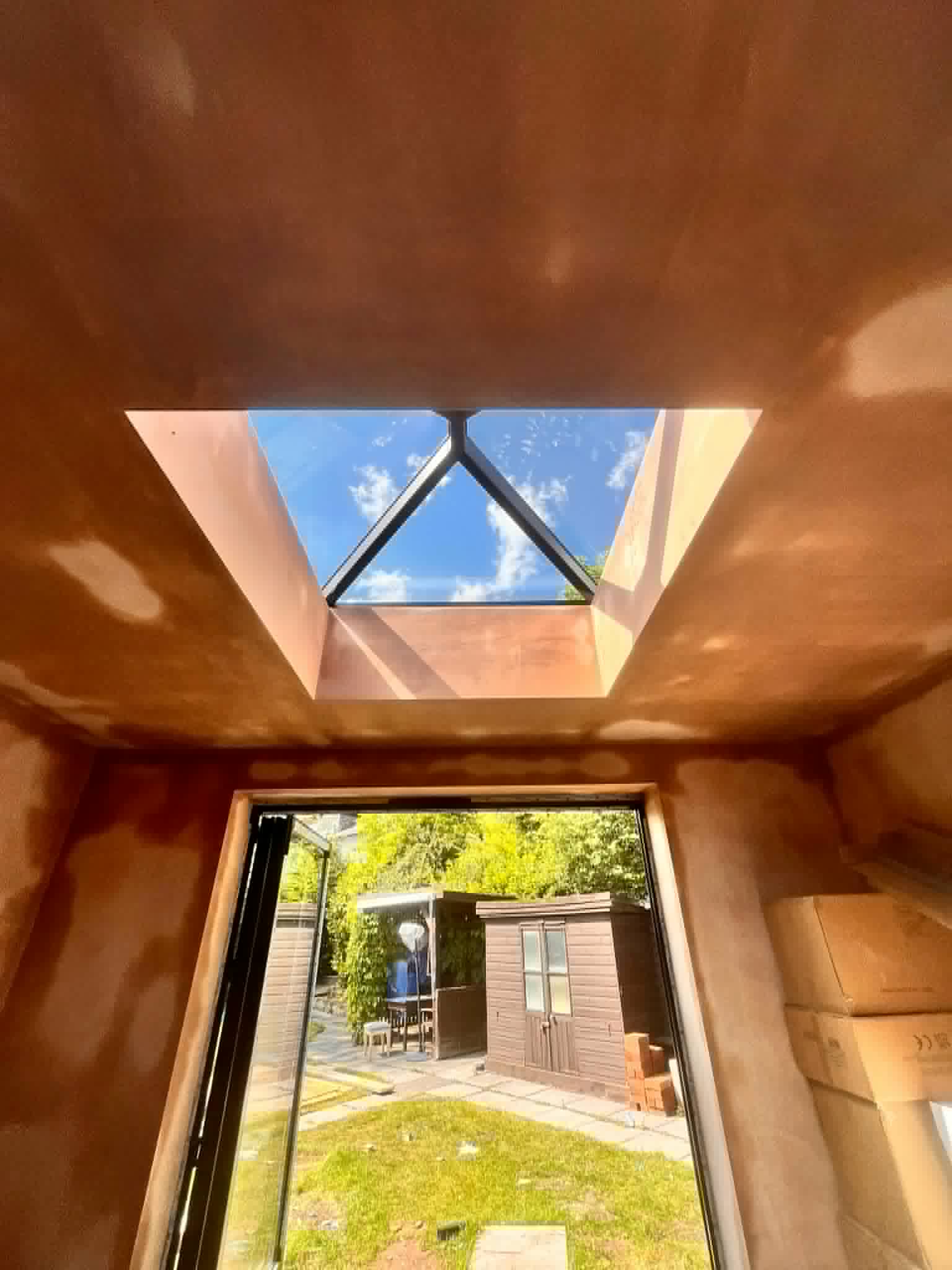 Fresh plaster finish around a pyramid skylight